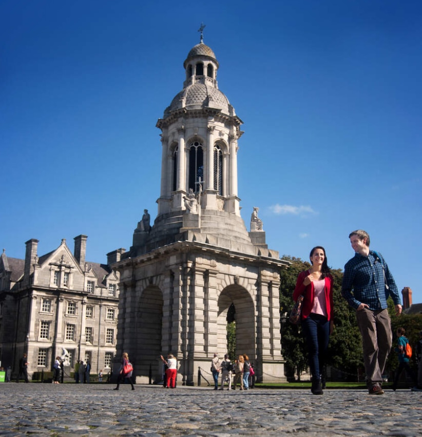 People walking outside Trinity College, Dublin.